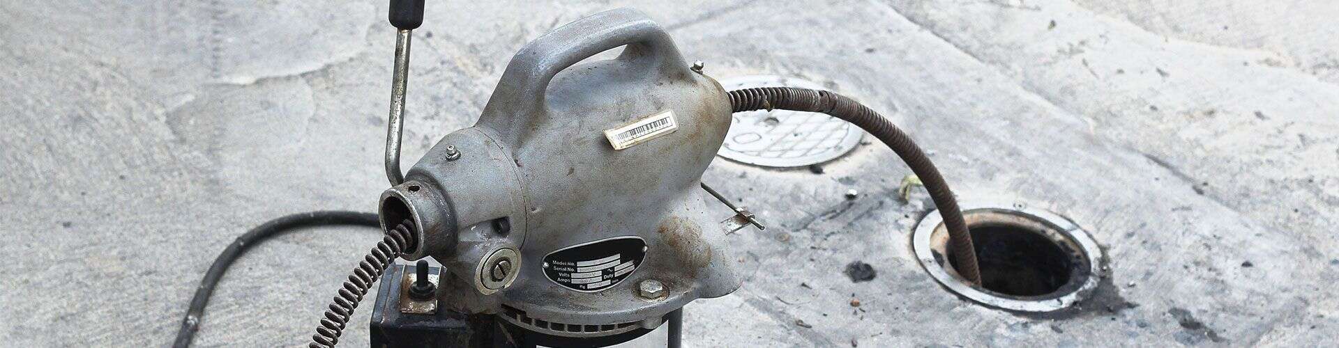 Drain cleaning tool removing debris from a clogged pipe in Canberra.