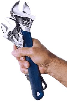 Hand holding adjustable wrench for plumbing repair work.